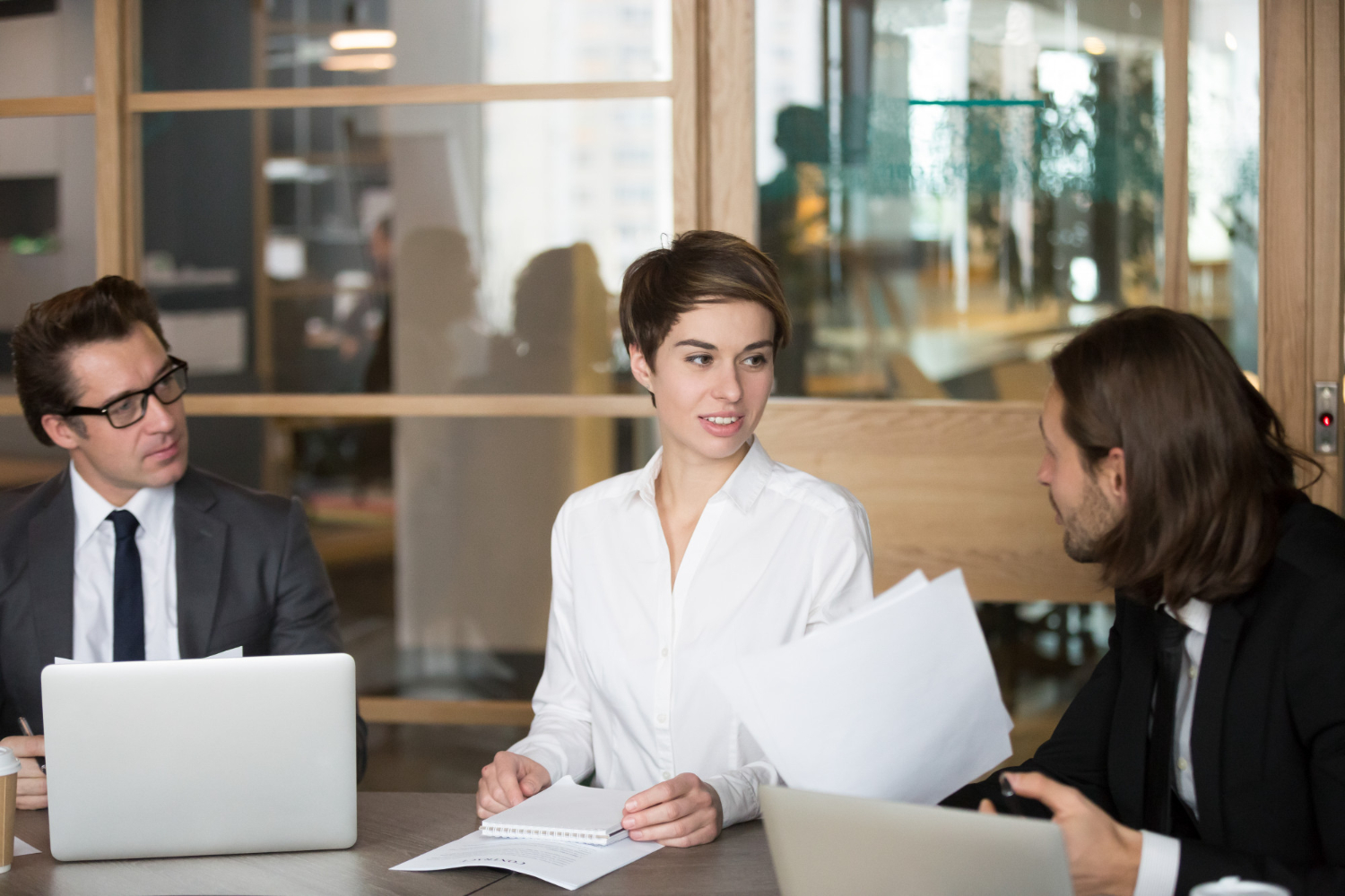 Legal process outsourcing discussion between three people