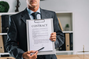 person holding contract in hand